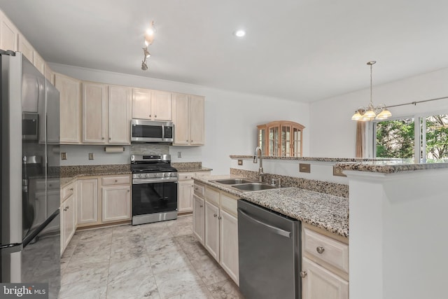 kitchen featuring decorative light fixtures, light stone countertops, a sink, marble finish floor, and stainless steel appliances