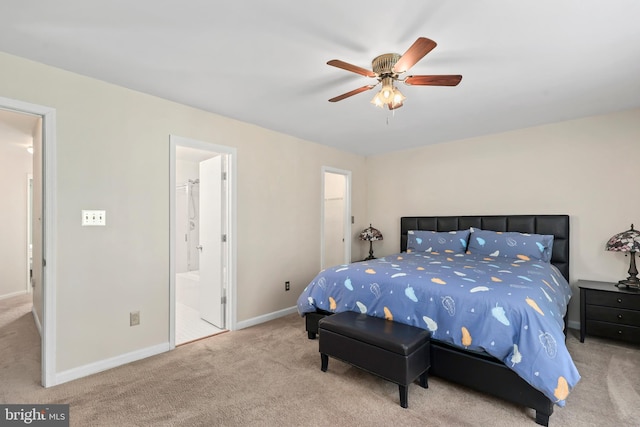 bedroom featuring baseboards, a ceiling fan, carpet, and ensuite bath