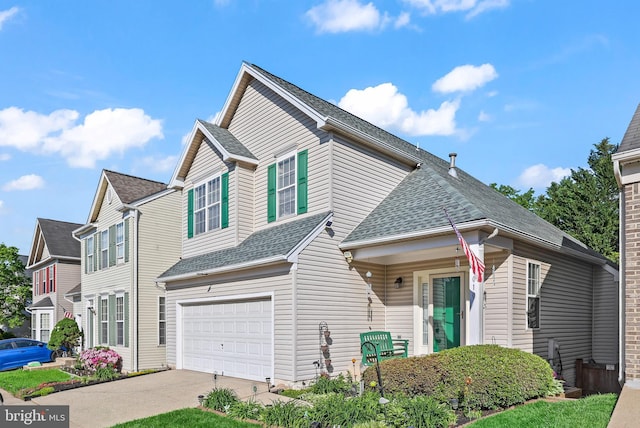 view of front of house with a garage, a shingled roof, and driveway