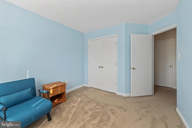 sitting room with baseboards and carpet flooring