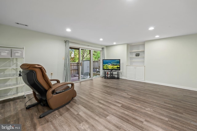sitting room with baseboards, recessed lighting, and wood finished floors