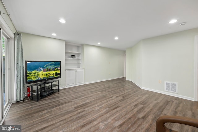 unfurnished living room with visible vents, recessed lighting, baseboards, and wood finished floors