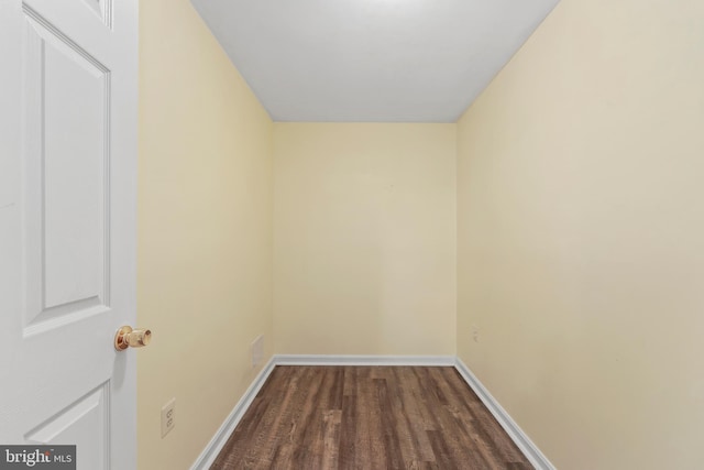 interior space with dark wood-style flooring and baseboards
