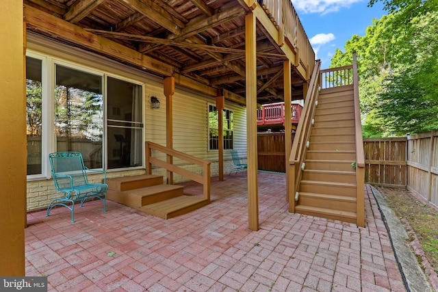 view of patio with a fenced backyard and stairway