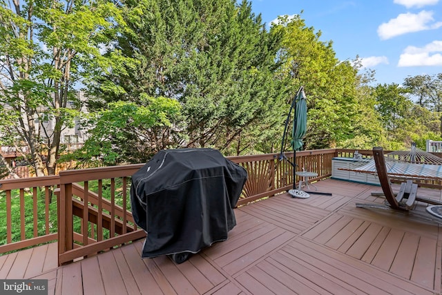 wooden terrace featuring a grill