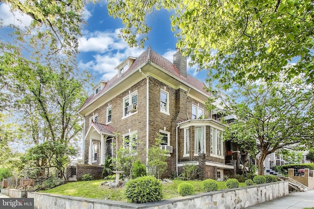 view of home's exterior featuring brick siding and a chimney