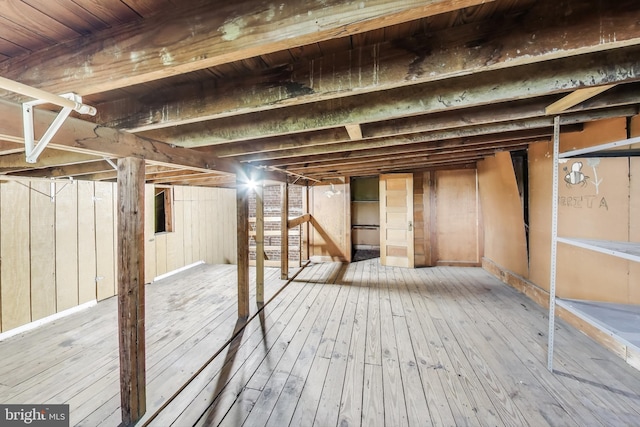 unfinished basement featuring hardwood / wood-style floors