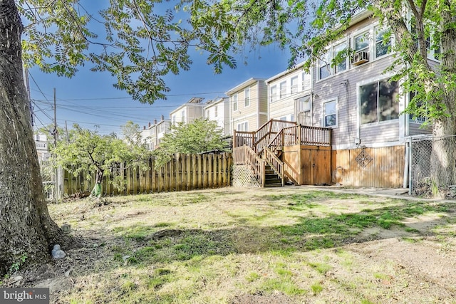 view of yard featuring stairway, a deck, and fence