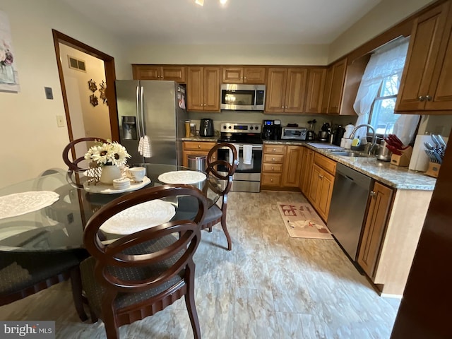 20416 Old York Rd, White Hall, MD 21161 - kitchen featuring a sink, appliances with stainless steel finishes, brown cabinets, and visible vents