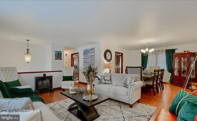 20416 Old York Rd, White Hall, MD 21161 - living room with a notable chandelier, wood finished floors, and a wood stove