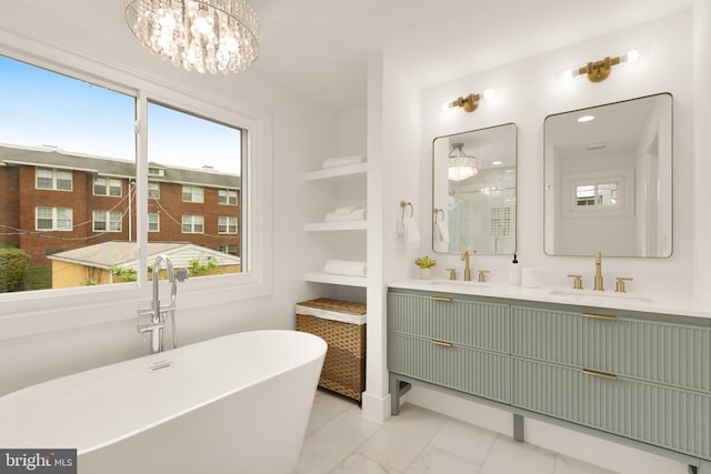 bathroom with a sink, marble finish floor, and a chandelier