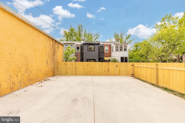 view of patio featuring fence and a gate