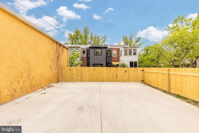 view of patio featuring fence and a gate