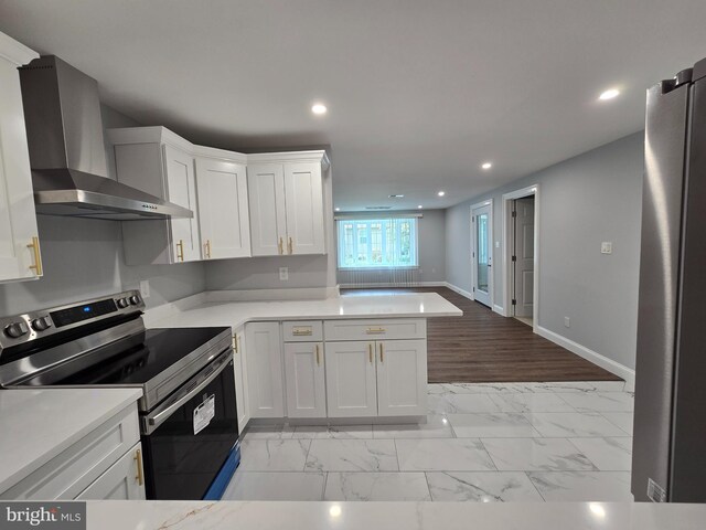 7002 Taylor Manor Ave, Temple Hills, MD 20748 - kitchen featuring appliances with stainless steel finishes, wall chimney exhaust hood, light marble finish flooring, recessed lighting, and light countertops