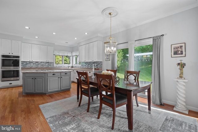 4209 Hardy Ridge Dr, Woodbridge, VA 22192 - dining room featuring an inviting chandelier, ornamental molding, recessed lighting, and light wood-style flooring