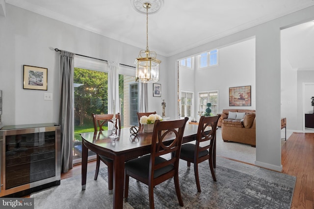 4209 Hardy Ridge Dr, Woodbridge, VA 22192 - dining area featuring wine cooler, plenty of natural light, an inviting chandelier, and crown molding