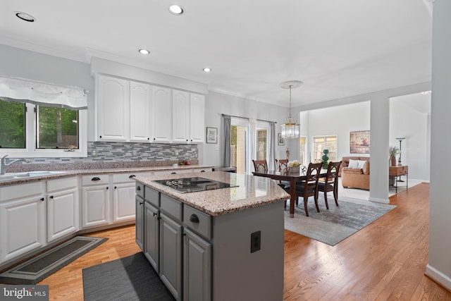 4209 Hardy Ridge Dr, Woodbridge, VA 22192 - kitchen featuring black electric stovetop, a sink, gray cabinets, a center island, and white cabinetry