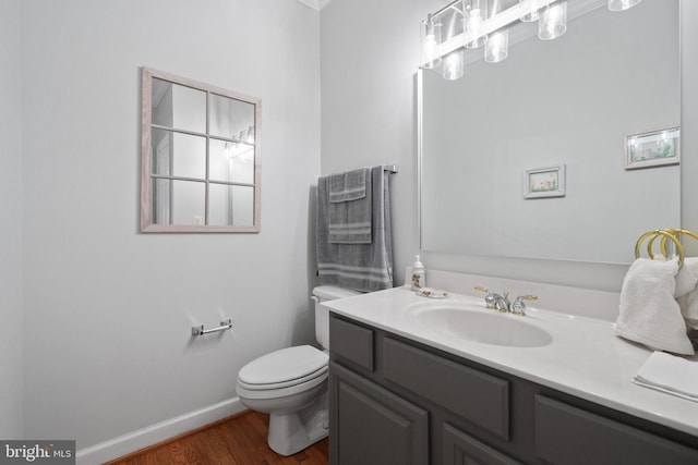 4209 Hardy Ridge Dr, Woodbridge, VA 22192 - bathroom featuring toilet, baseboards, wood finished floors, and vanity