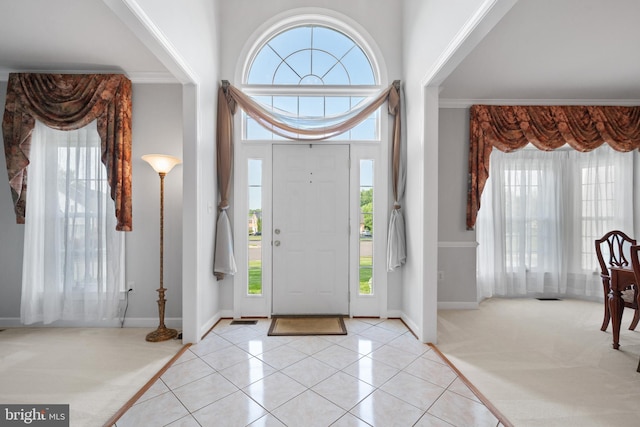 4209 Hardy Ridge Dr, Woodbridge, VA 22192 - entrance foyer with a healthy amount of sunlight, baseboards, crown molding, and light tile patterned flooring