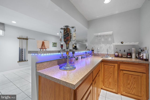 4209 Hardy Ridge Dr, Woodbridge, VA 22192 - kitchen featuring light tile patterned floors, recessed lighting, brown cabinetry, and a sink