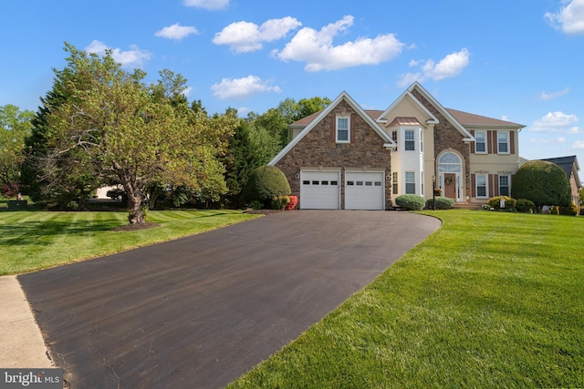 4209 Hardy Ridge Dr, Woodbridge, VA 22192 - view of front facade featuring an attached garage, aphalt driveway, a front yard, and stone siding