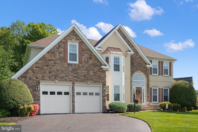 4209 Hardy Ridge Dr, Woodbridge, VA 22192 - view of front of home with a garage, a front lawn, stone siding, stucco siding, and driveway