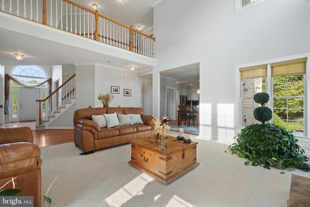 4209 Hardy Ridge Dr, Woodbridge, VA 22192 - living room with carpet floors, ornamental molding, stairway, and a towering ceiling