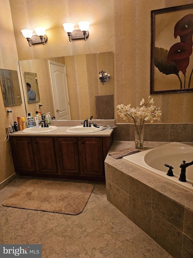 full bath with double vanity, a bath, and a sink