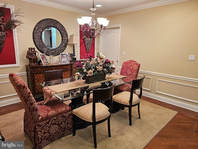 dining room with an inviting chandelier, recessed lighting, ornamental molding, wood finished floors, and wainscoting
