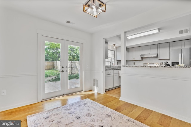 entryway with a sink, french doors, and visible vents