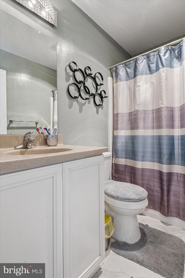 full bathroom featuring vanity, marble finish floor, toilet, and a shower with curtain