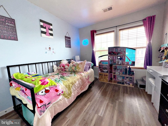 21 Holmes Dr, Charles Town, WV 25414 - bedroom with baseboards, visible vents, and wood finished floors