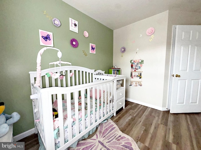 21 Holmes Dr, Charles Town, WV 25414 - bedroom with baseboards, a crib, and wood finished floors