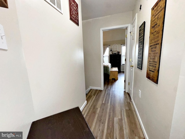21 Holmes Dr, Charles Town, WV 25414 - hallway featuring baseboards, visible vents, and wood finished floors