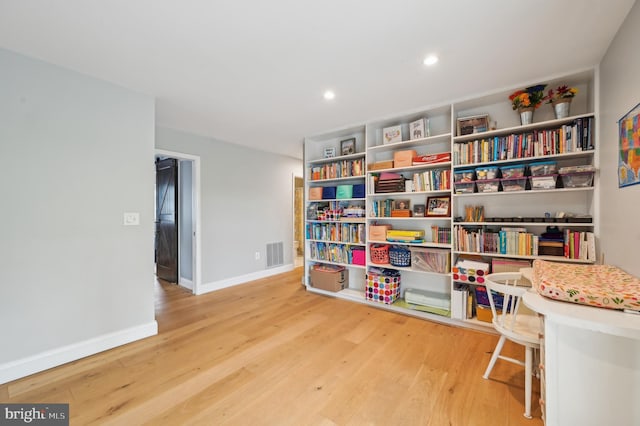 sitting room with visible vents, wood finished floors, baseboards, and recessed lighting
