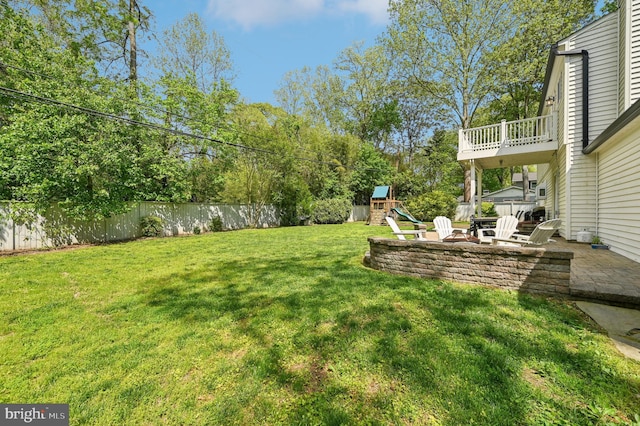 view of yard with a patio area, a playground, and fence