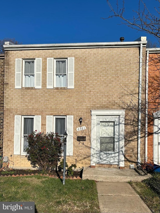 view of property with brick siding
