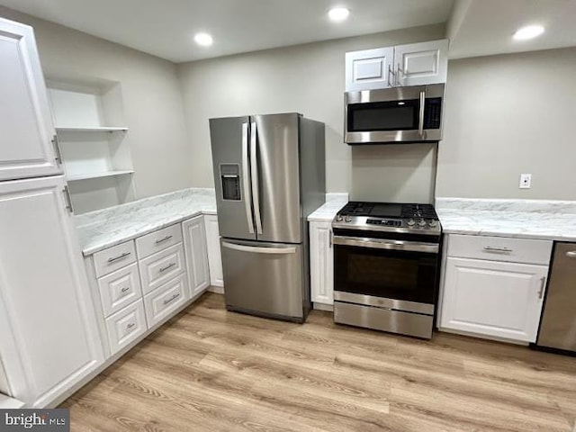 kitchen featuring white cabinetry, light wood-type flooring, open shelves, and appliances with stainless steel finishes