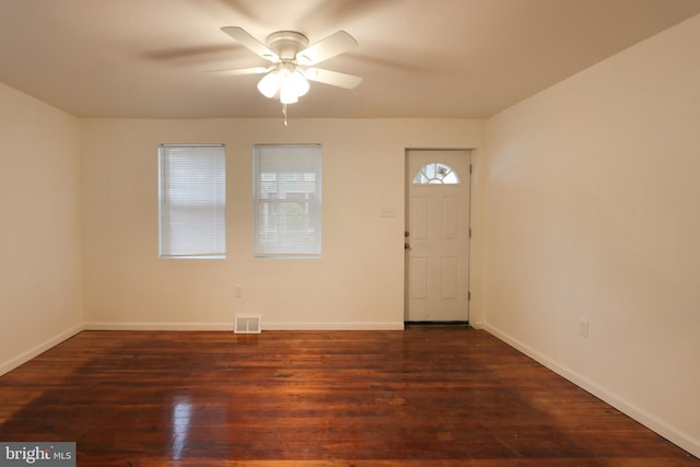 spare room featuring visible vents, a ceiling fan, baseboards, and hardwood / wood-style flooring
