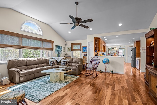 living area with recessed lighting, ceiling fan, wood finished floors, and high vaulted ceiling