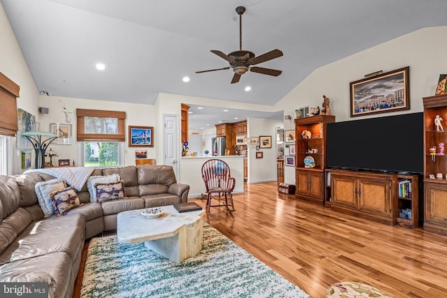 living room with light wood-style floors, a ceiling fan, recessed lighting, and lofted ceiling