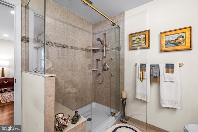 bathroom with recessed lighting, a stall shower, and toilet