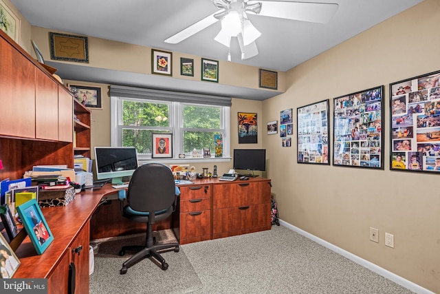 office area with baseboards, a ceiling fan, and carpet