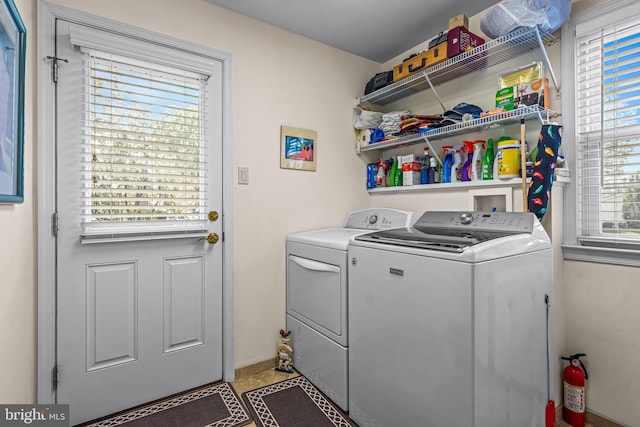 clothes washing area with baseboards, laundry area, and independent washer and dryer