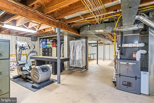 unfinished basement featuring heating unit