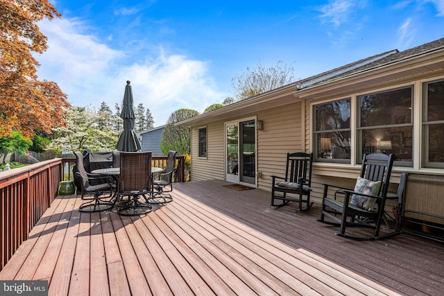 deck with outdoor dining area