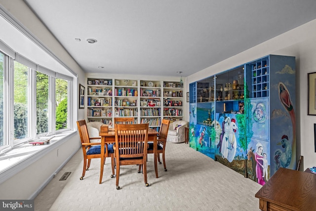 carpeted dining space featuring baseboards and visible vents