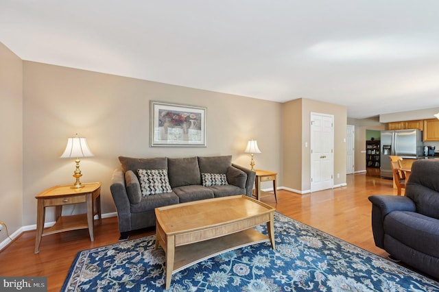 living room with light wood-type flooring and baseboards