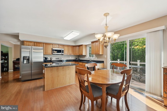dining room with an inviting chandelier, light wood finished floors, and visible vents