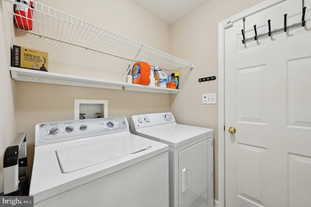 clothes washing area with washing machine and dryer and laundry area